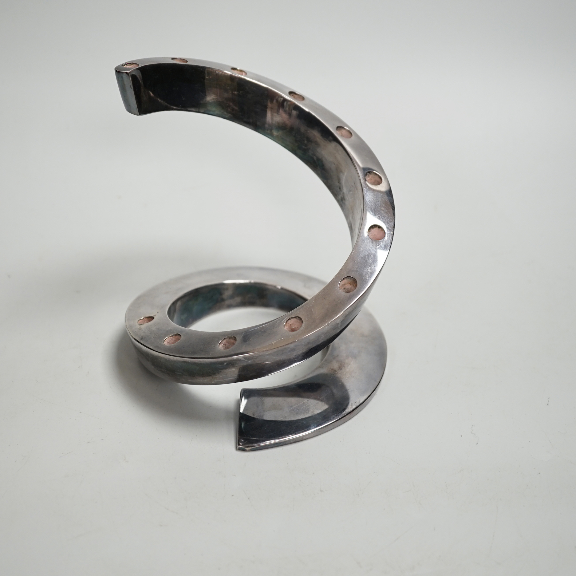 A contemporary Danish style coiled candlestick in chrome finish, stamped Dansk Designs France BV, 13.3cm high